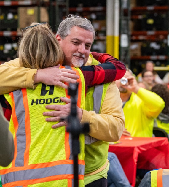 HODGE employees hugging eachother at team event