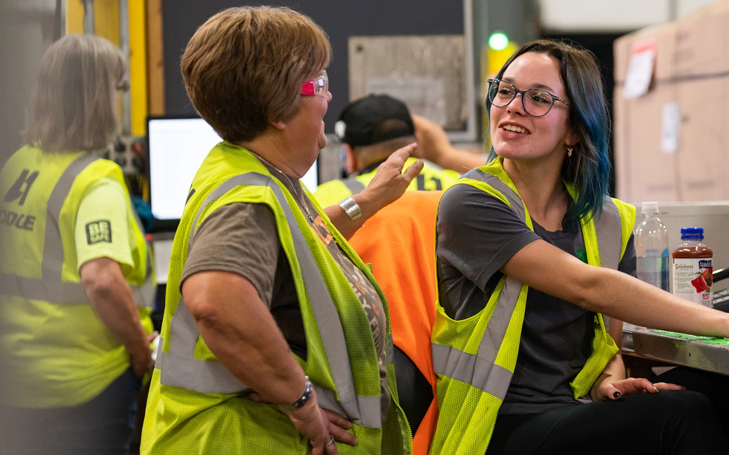 HODGE warehouse employees talking at desk