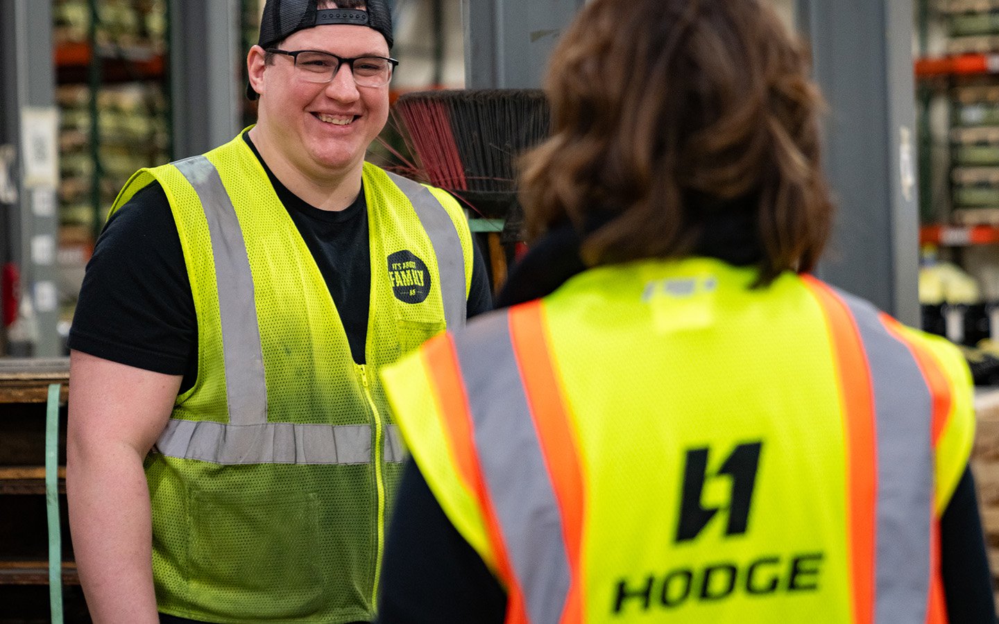 HODGE employees talking to eachother wearing while safety vests