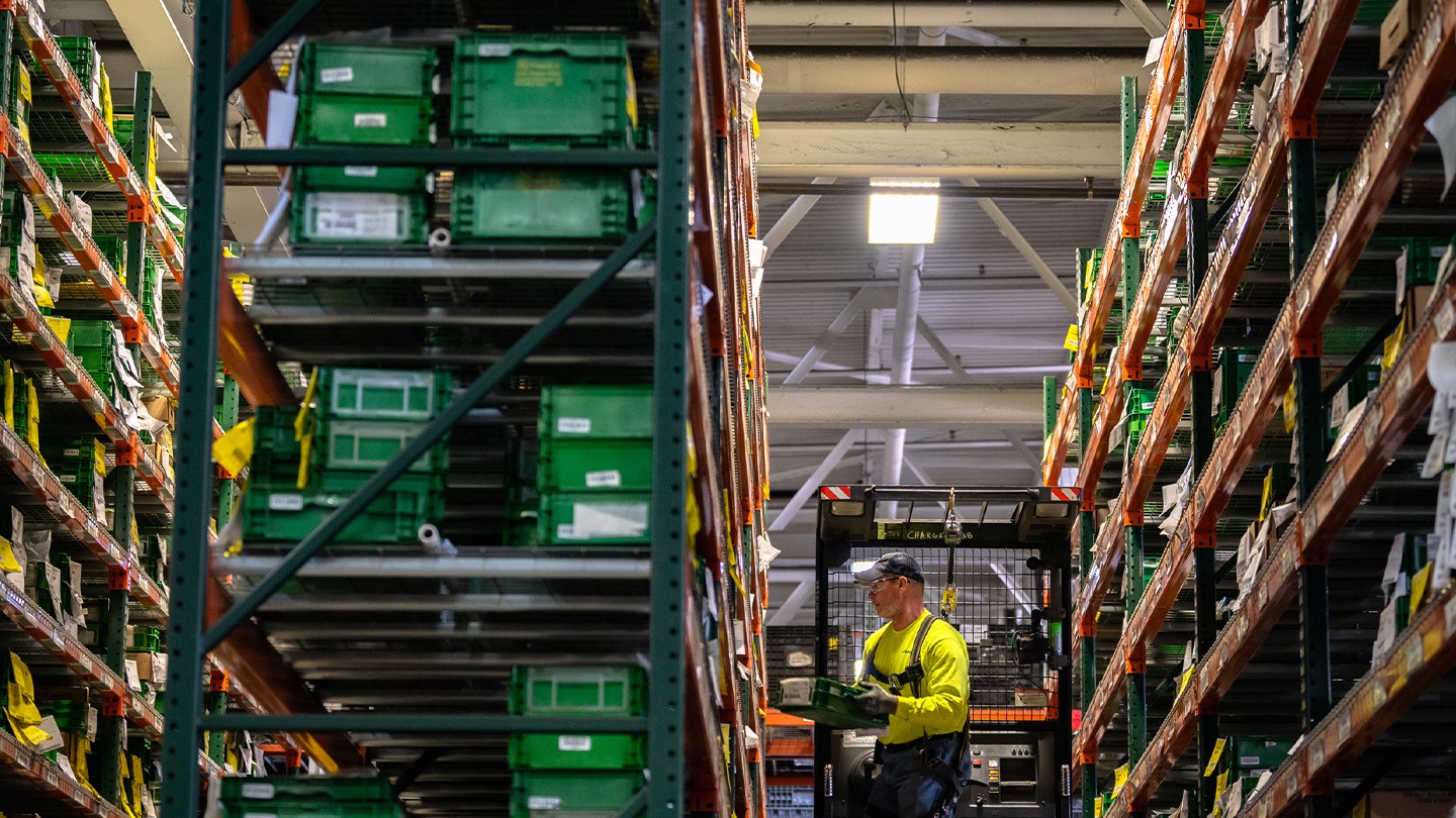 HODGE employee on forklift stocking shelves