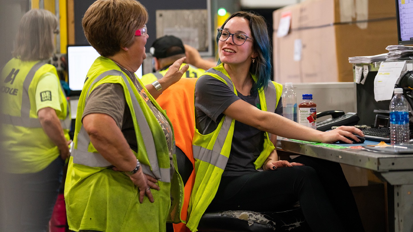 HODGE warehouse employees communication at desk